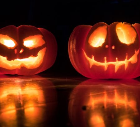 carved pumpkin heads glowing